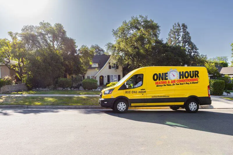 One Hour Heating and Air Conditioning tech driving the wrapped work van through the streets of Surprise, AZ.