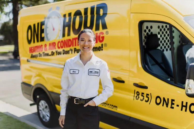 One Hour Heating and Air Conditioning- Phoenix West Valley tech standing in front of a wrapped van ready to work on HVAC issues for a Peoria, AZ home.