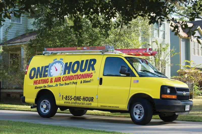 An empty One Hour Heating and Air Conditioning van wrapped, sitting outside of Phoenix West Valley home.